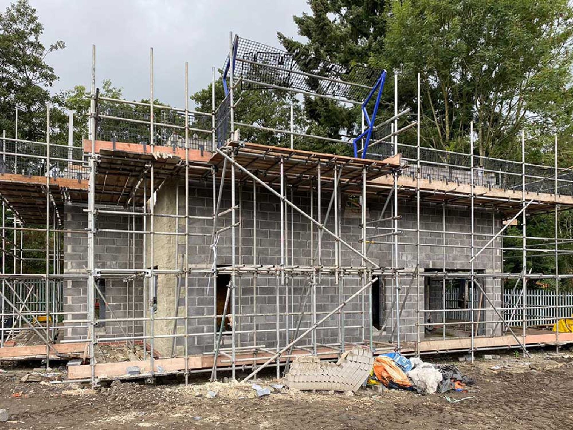 Construction progress of five bedroom manor house with breeze blocks and scaffolding.