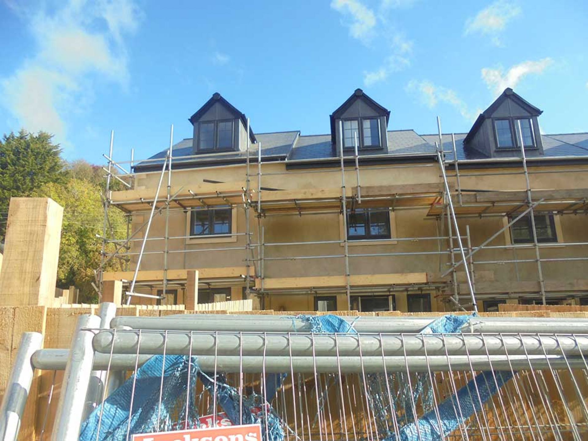 View looking up of housing development with scaffolding outside.