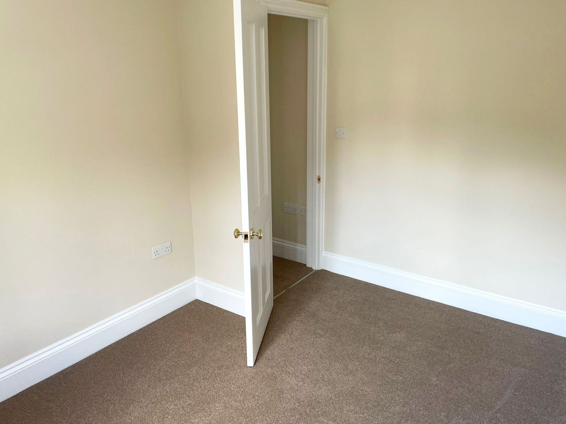 Cranborne house completed room with open door and brand new brown carpet fitted.