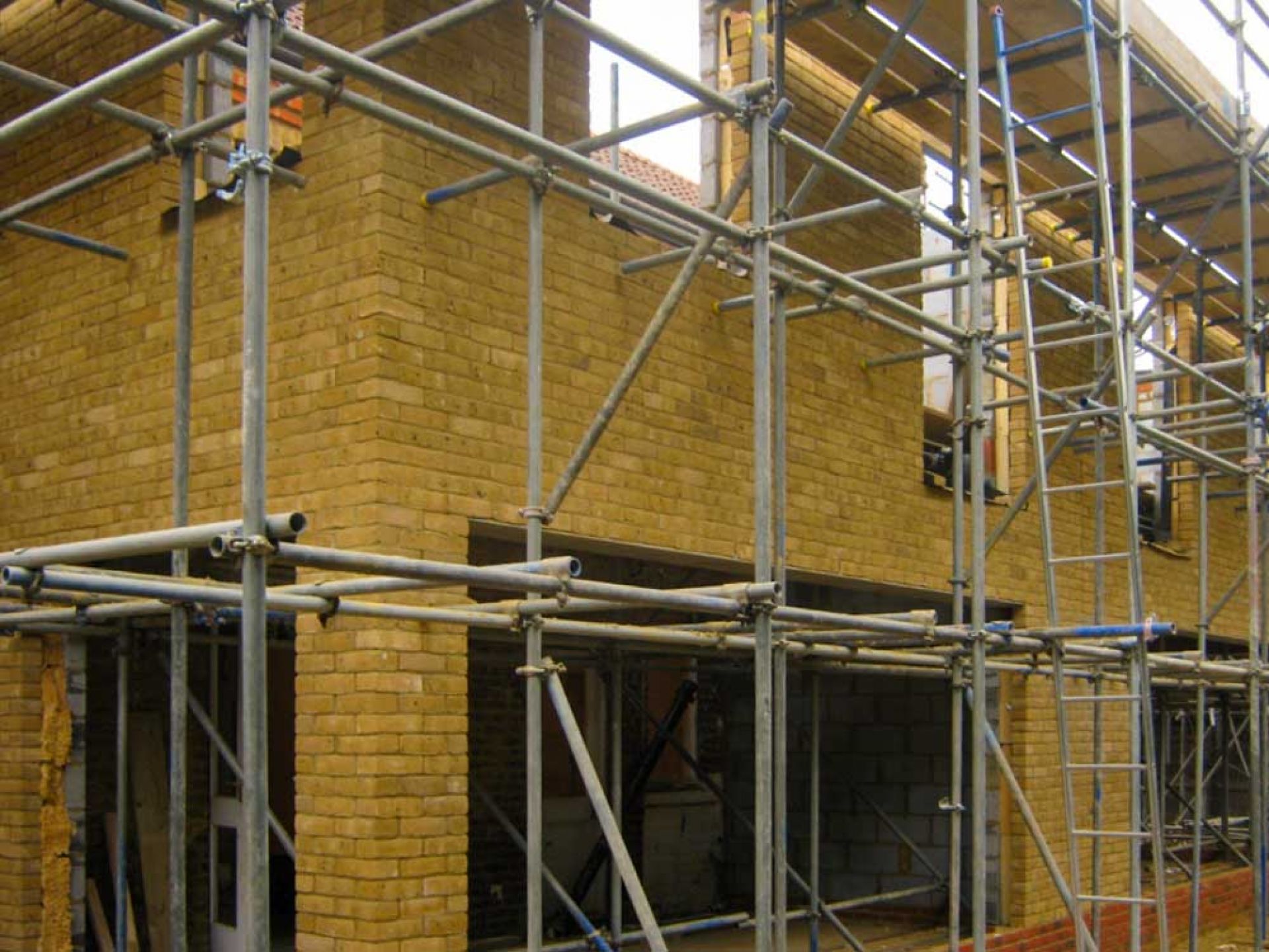 Close up of house construction with scaffolding.