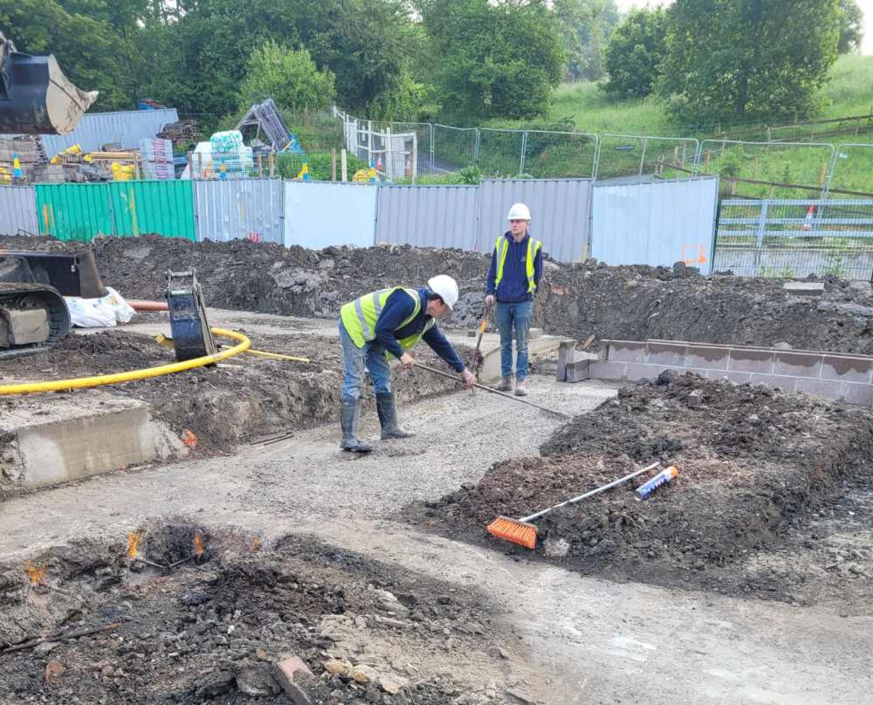 Early stages of the 5 townhouse development with foreman checking the ground.