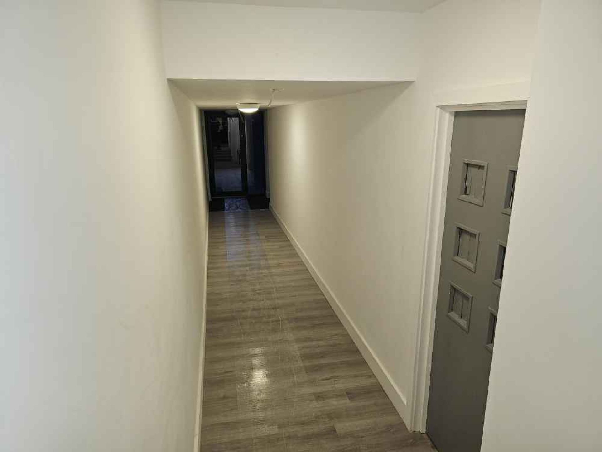 Completed hallway at pegs lane flat development with grey front door.