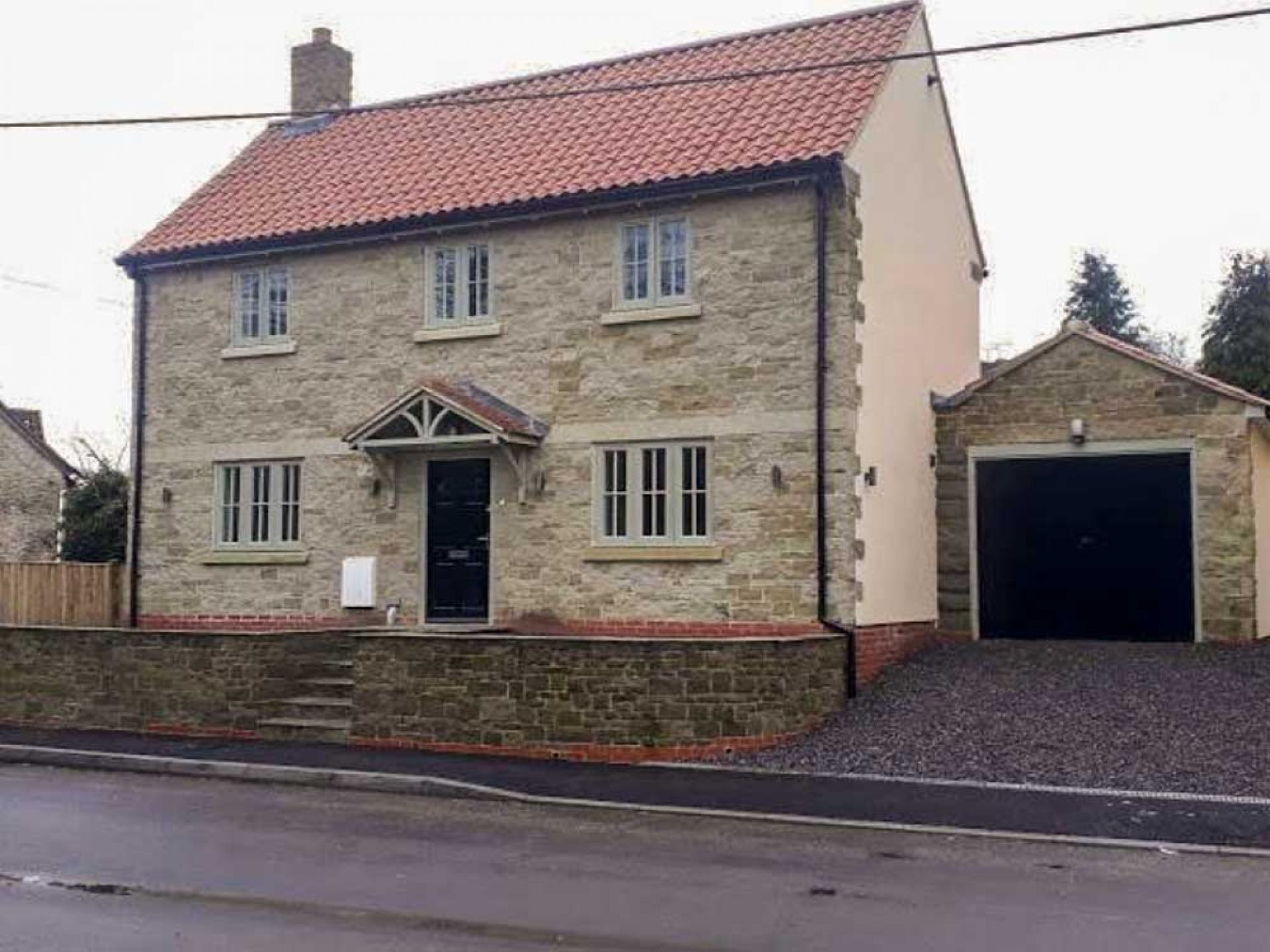 Front view of new large detached house.