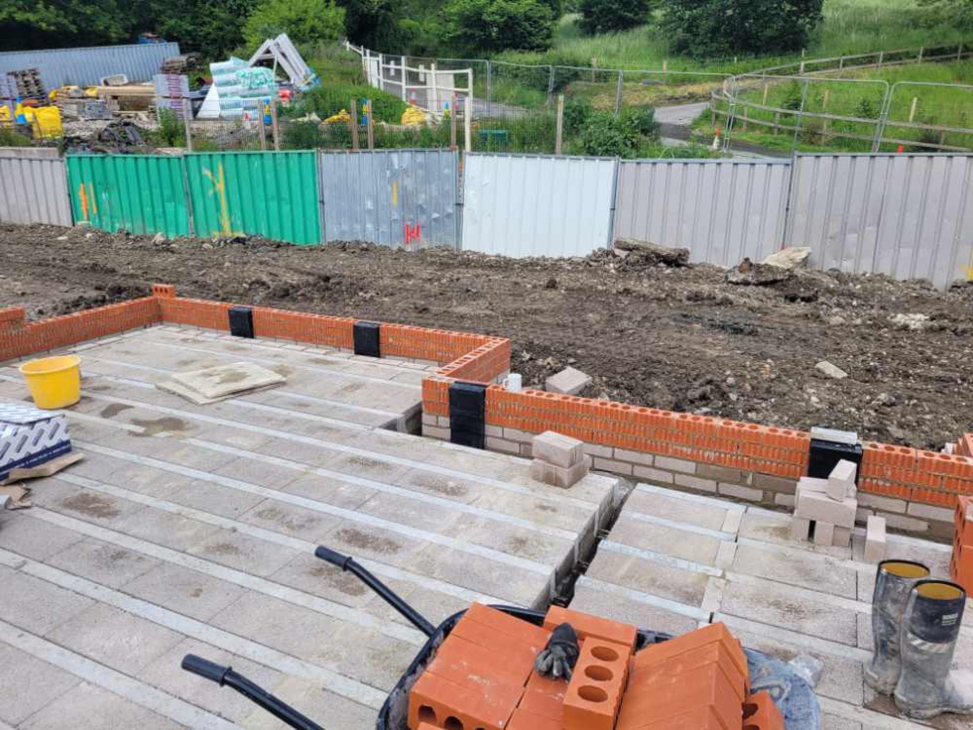 5 townhouse foundations being set with lower brick work completed.