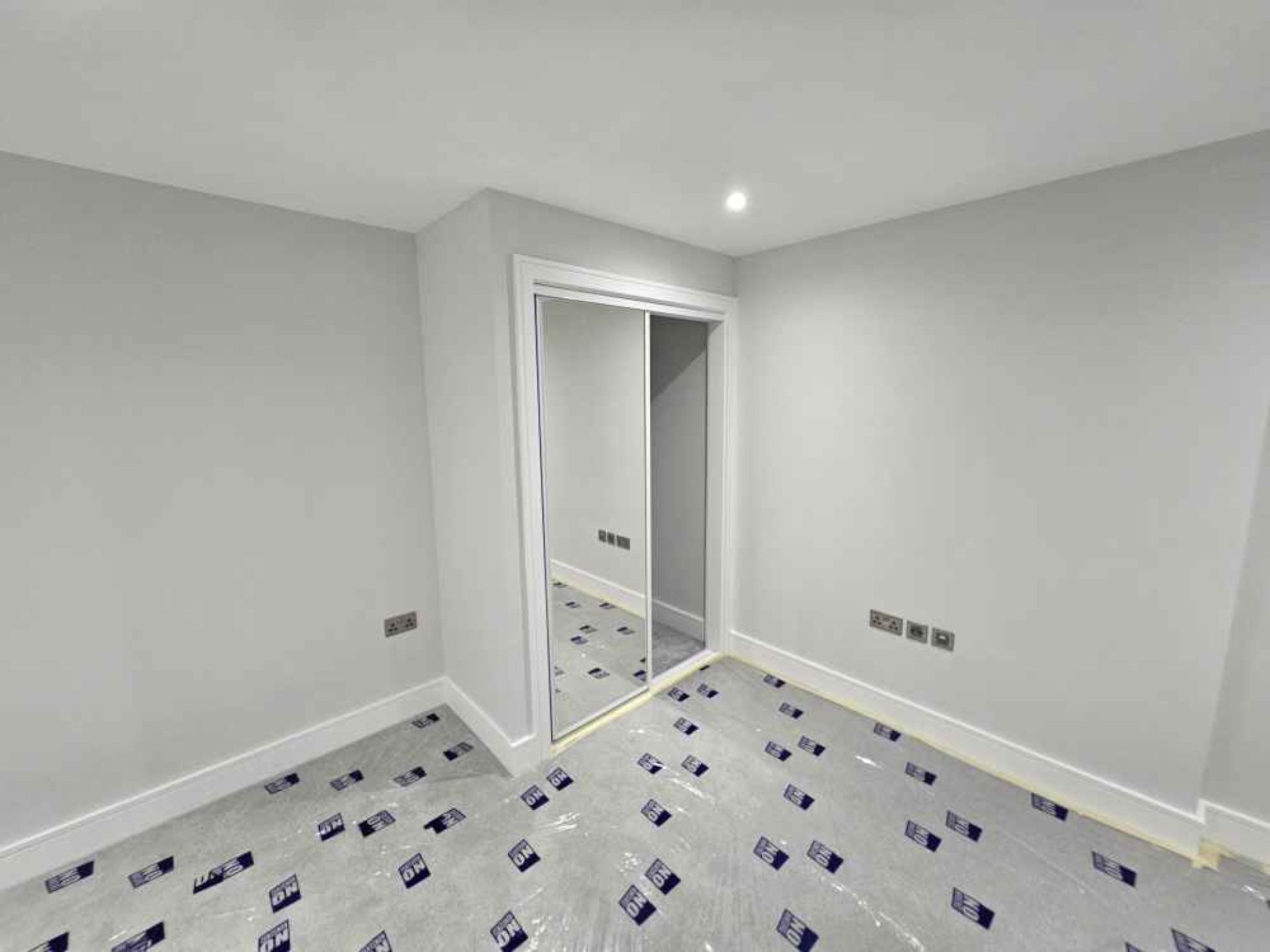 Completed flat at pegs lane london from the inside. White walls and spot lighting.