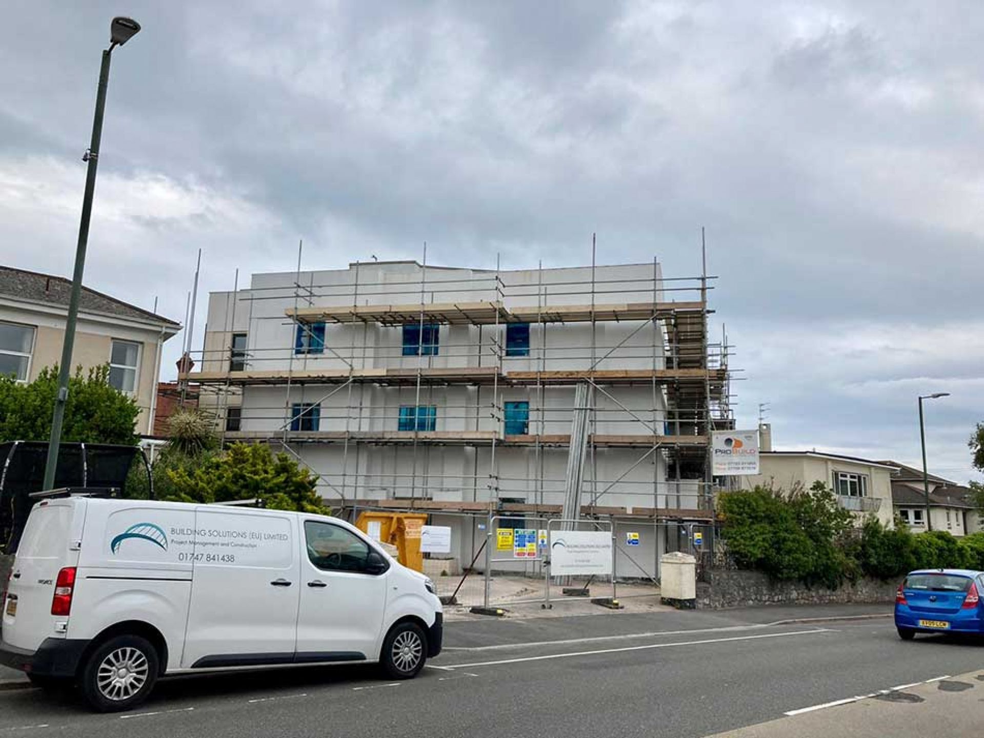 Hotel mid development with scaffolding outside and a white van with building solutions eu limited on the side.