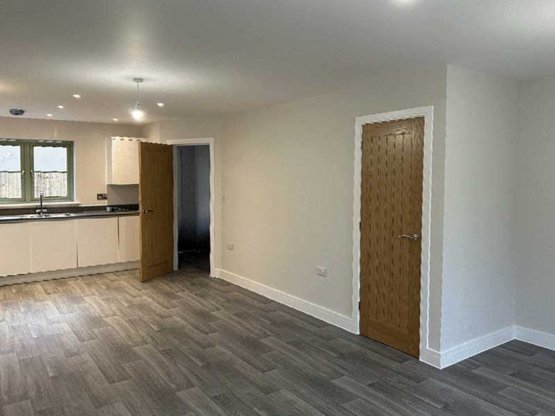 View of inside one of the terraced houses at the bourton mill site looking at the kitchen area from the other end of the building.