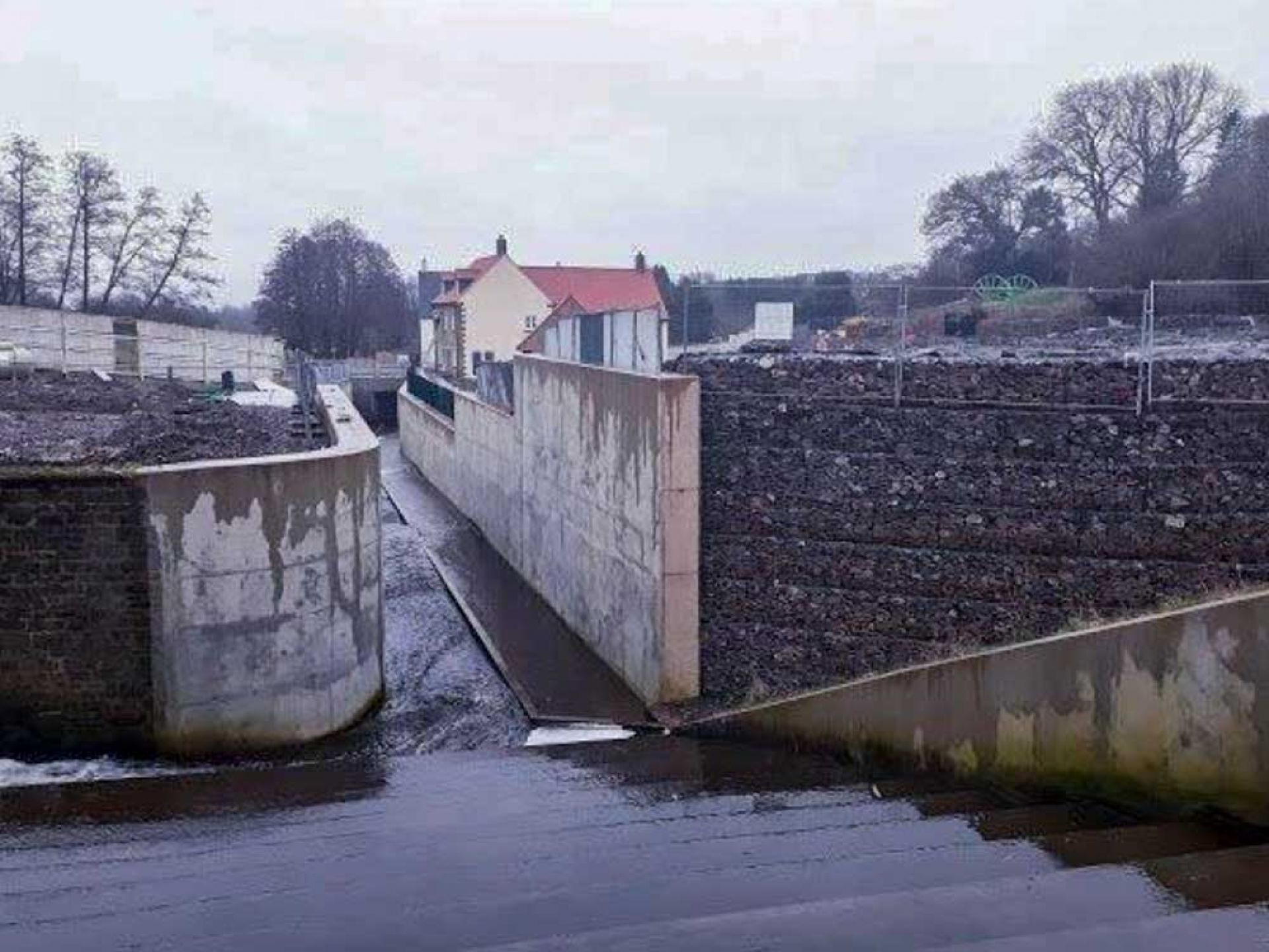 Flood spillway looking into flood channel past new housing.