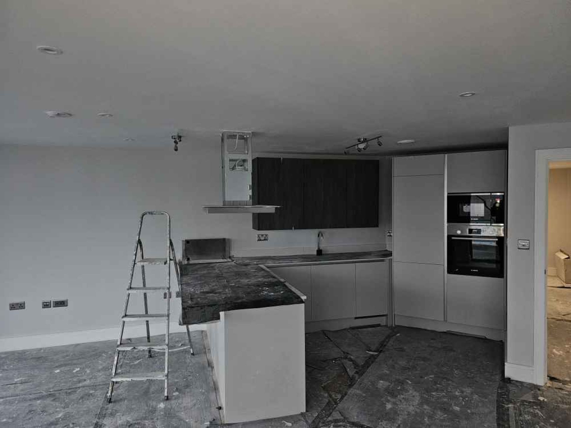 Open plan kitchen area at the halfway stage of development. Oven and cupboards being fitted.
