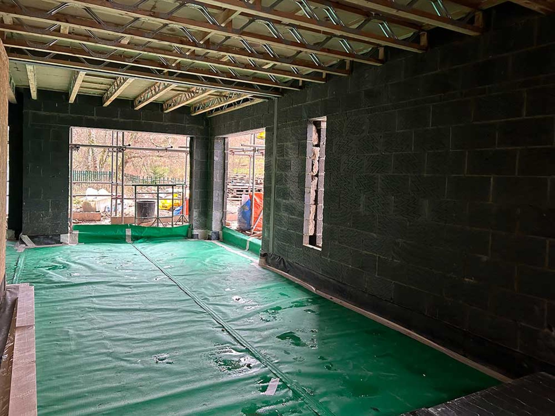 Internal construction of five bedroom manor house inside a large room with a gap for a window at the end.