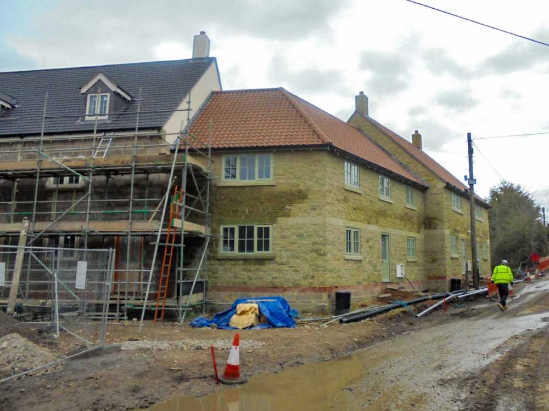 Building phase of new housing development with scaffolding attached.