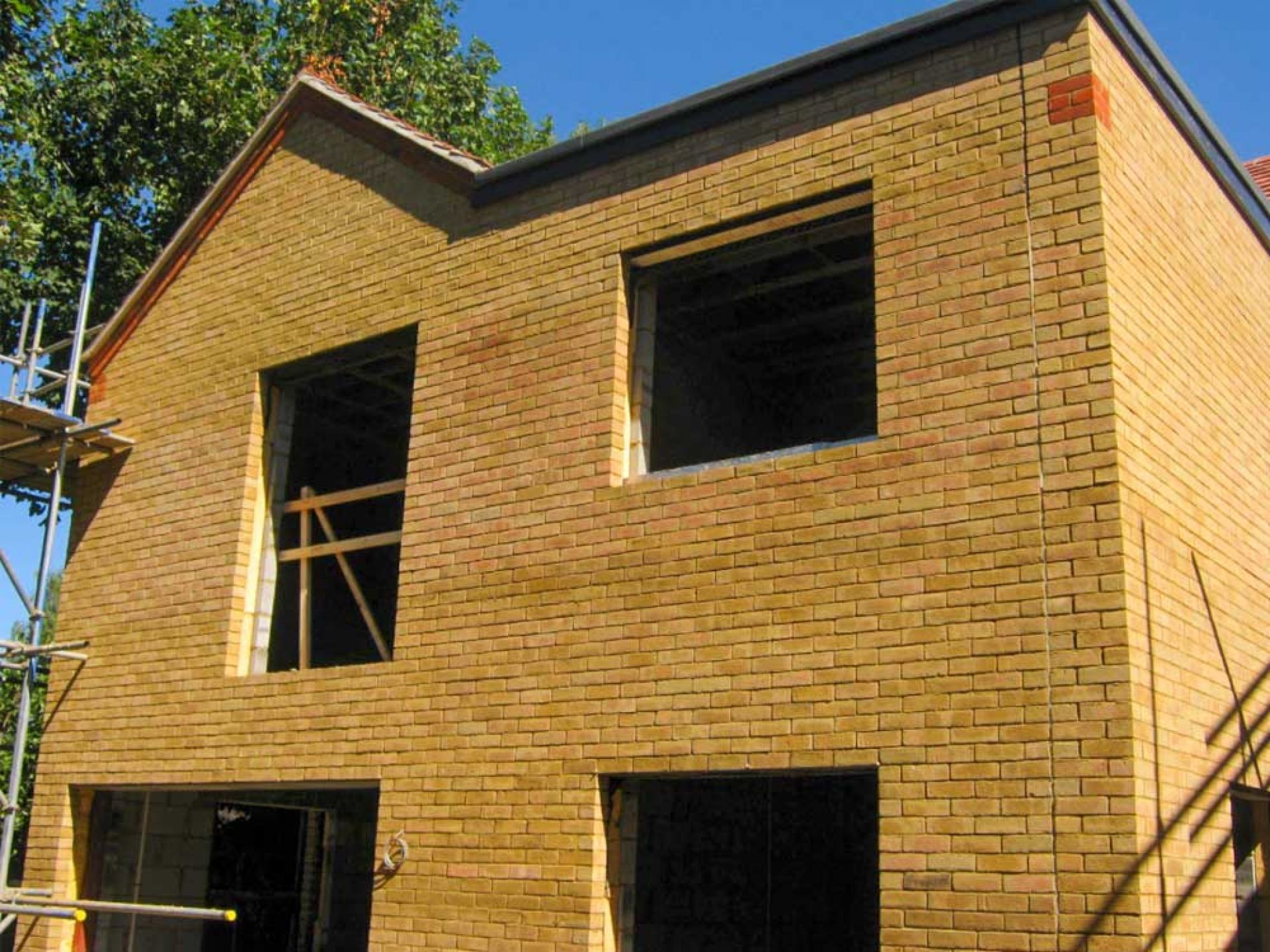 House construction with completed brickwork with scaffolding removed.