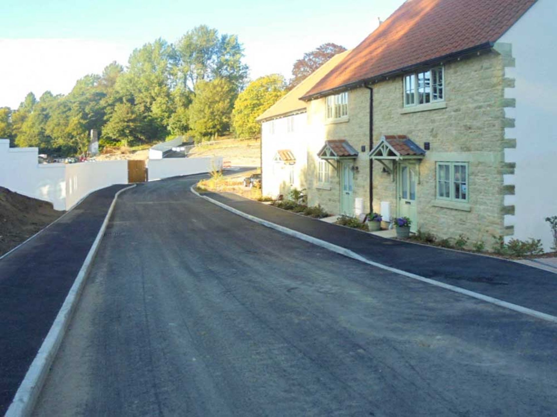 Completion of new highway past some new housing looking down hill.