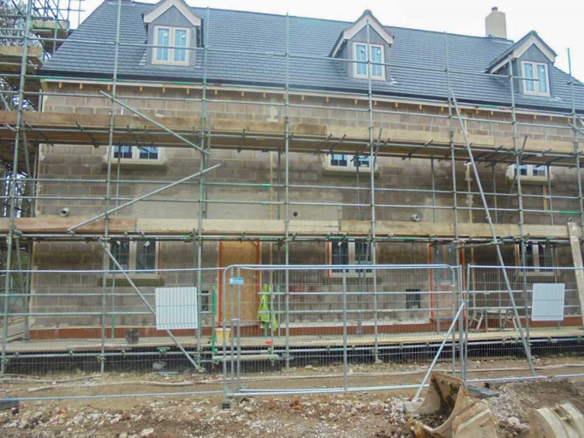 Scaffolding outside of three new houses as part of a new development.