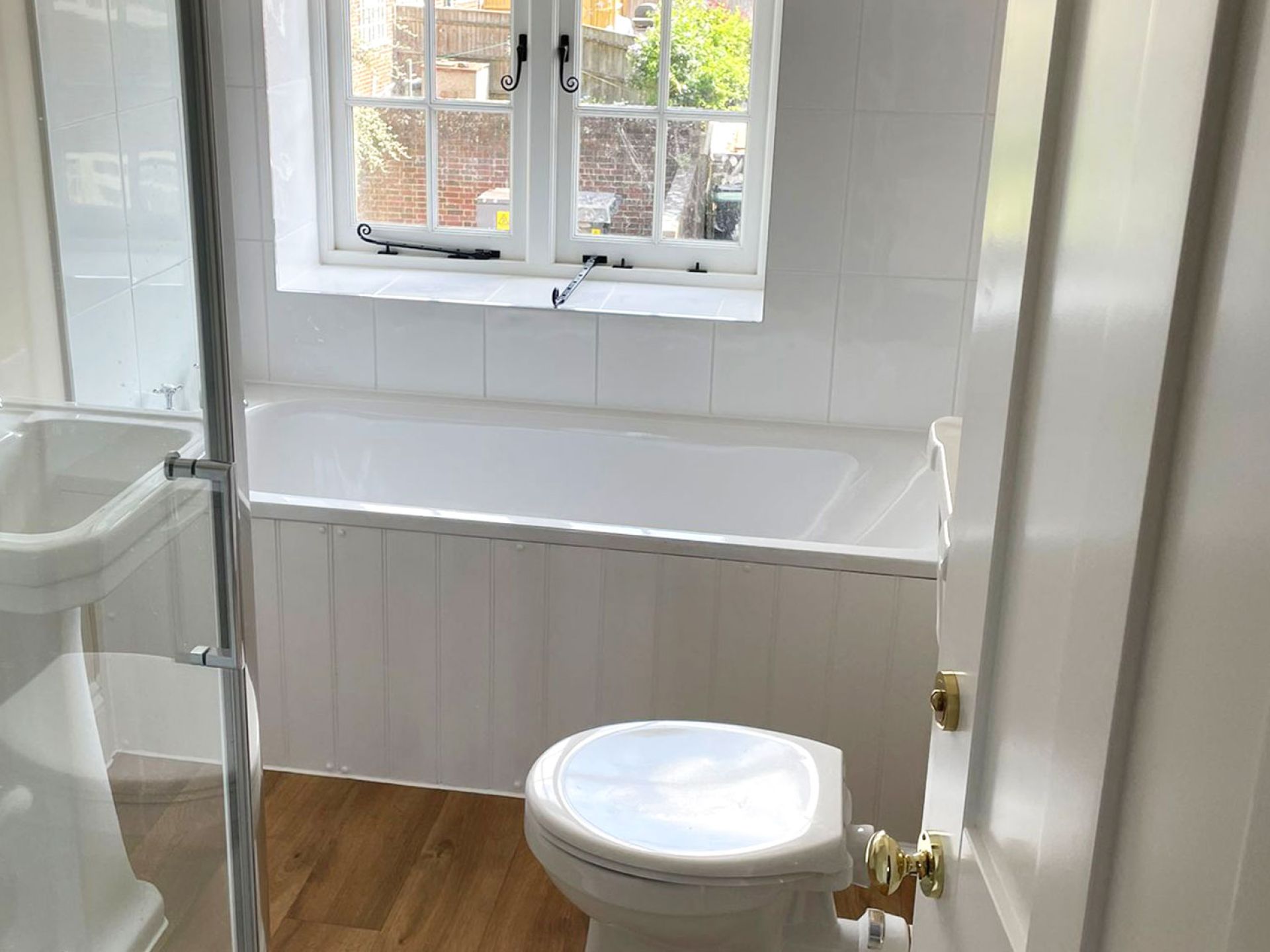 Completed and refurbished toilet in cranborne house with white walls and details.