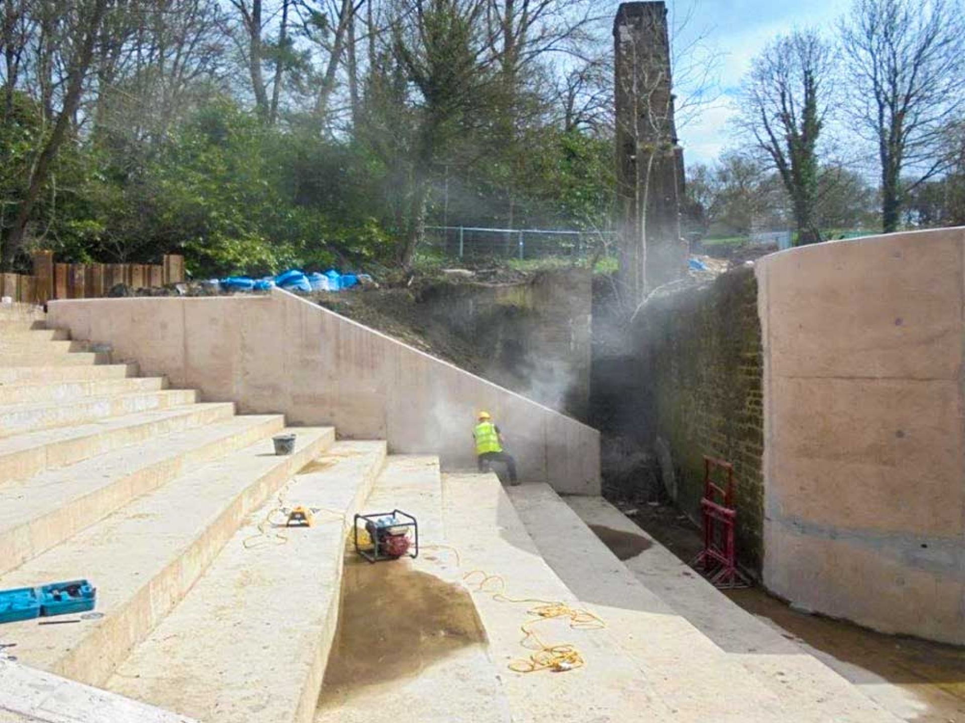 Man working on spillway concrete steps.