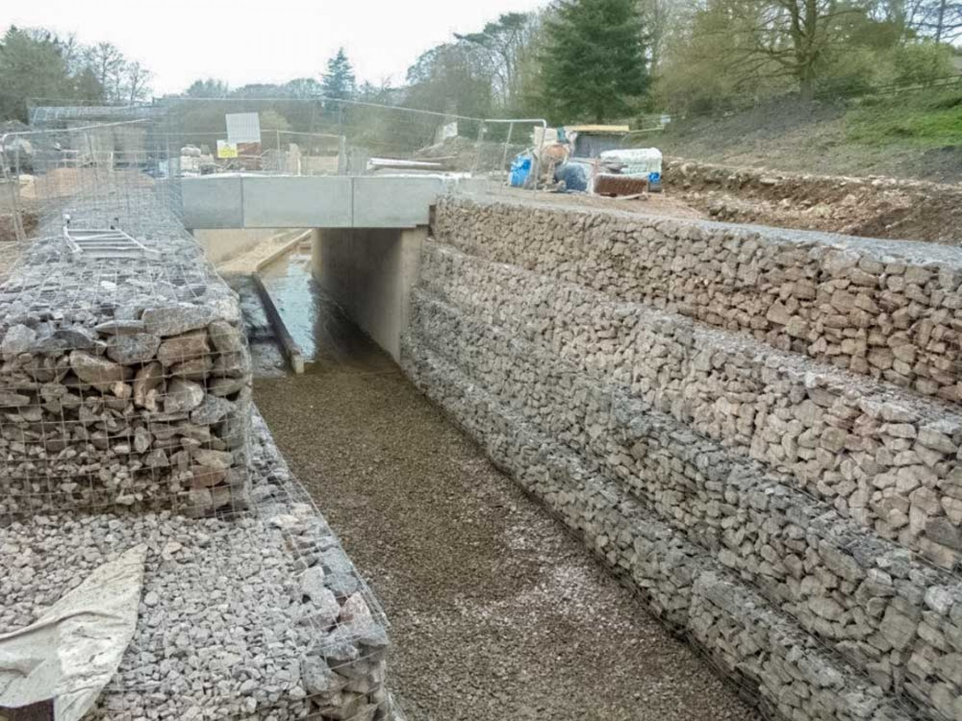 Concrete road bridge construction with bridge assembled and deep channel benath.